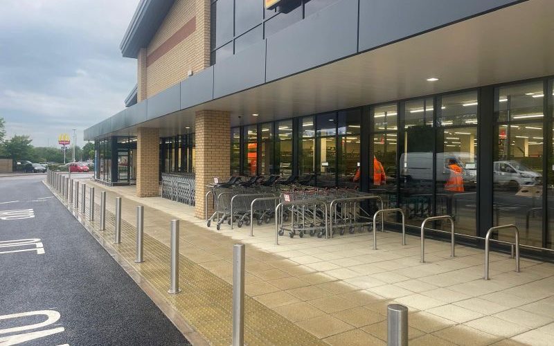 New kerbs, paving and stainless bollards outside a finished ALDI store